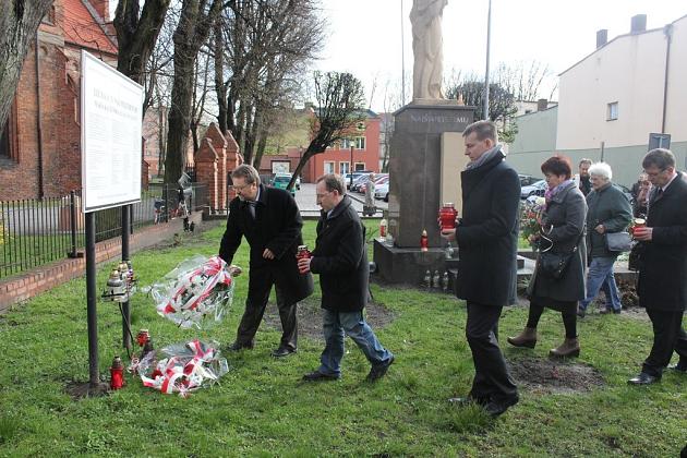 Kwiaty pod tablicą upamiętniającą ofiary katastrofy smoleńskiej